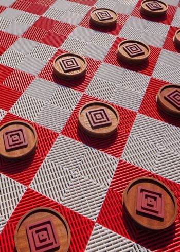 A checkerboard with wooden pieces on it.